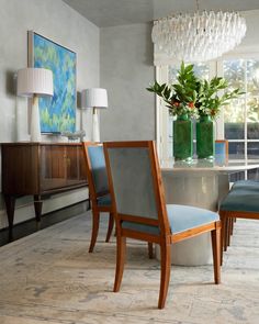 a dining room table with blue chairs around it