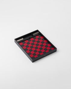 a red and black checkered tray on a white surface