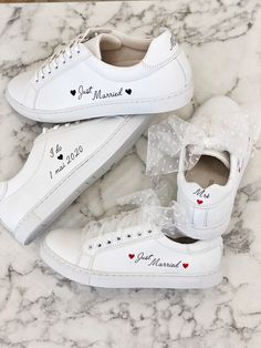 two pairs of white shoes with hearts and i love my husband written on the side