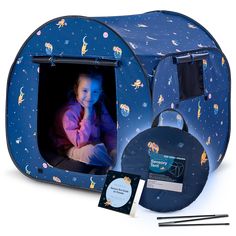 a child's photo in a blue space themed play tent with its contents laid out