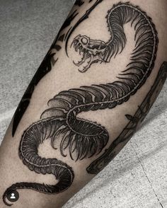 a black and white photo of a dragon tattoo