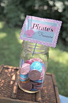 a jar filled with coins sitting on top of a table