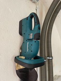 a cordless sander is mounted to the side of a wall