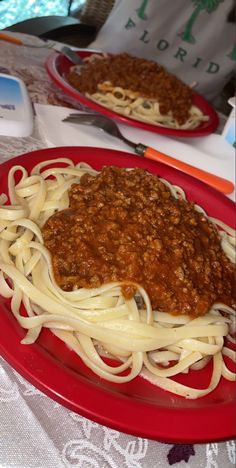 two plates of spaghetti on a table