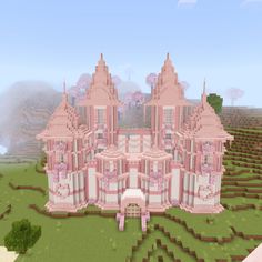 a large pink castle in the middle of a field