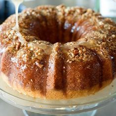 a bundt cake is being drizzled with icing