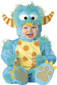 a baby dressed in a blue monster costume