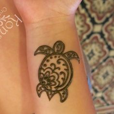 two people with tattoos on their arm and wrist, one has a turtle tattoo on it