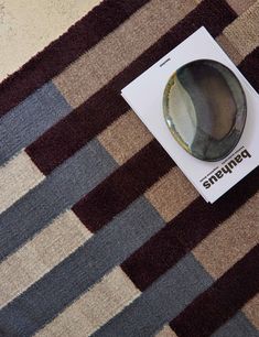 an unopened box sitting on top of a rug