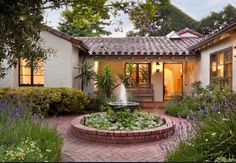 a house with a fountain in the front yard