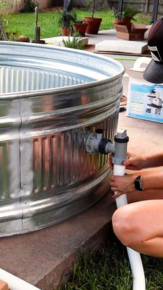 two women are working on an outdoor water heater