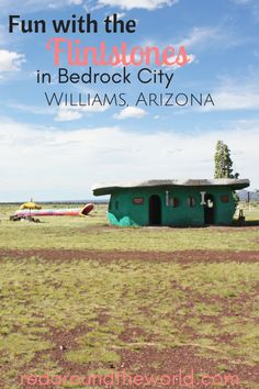 a green building with the words fun with the flintstones in beddock city williams arizona