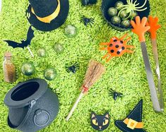 halloween decorations on green grass with witches and bats