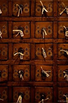 an old wooden drawer with lots of keys and numbers on it's sides in chinese characters