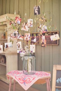 a vase filled with flowers sitting on top of a table next to a wooden chair