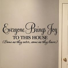 there is a wall decal that says everyone brings joy to this house, some as they enter