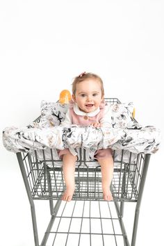 a baby is sitting in a shopping cart