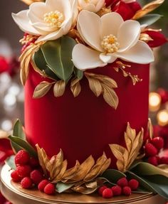 a red and gold cake with flowers on top