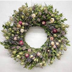 a wreath with dried flowers and greenery