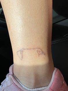 a small tattoo on the ankle of a woman