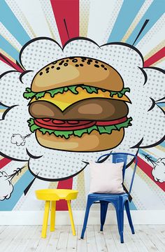 a wall mural with a large hamburger on it's face and clouds in the background