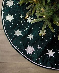 a christmas tree skirt with snowflakes on it