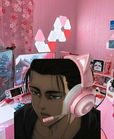 a person with headphones on in front of a computer