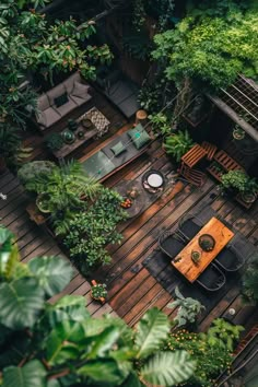 an overhead view of a patio with tables and chairs surrounded by trees in the background