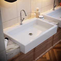 two white sinks sitting next to each other in a bathroom