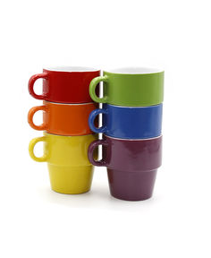 four different colored coffee cups stacked on top of each other