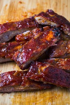 ribs covered in bbq sauce on a cutting board