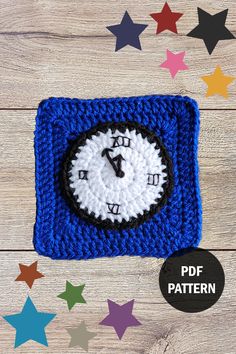 a crocheted square with a clock on it and stars around the perimeter, all in different colors