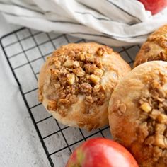 some apples and muffins on a cooling rack