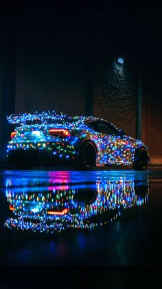 a car covered in christmas lights parked on the street