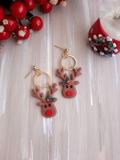 pair of reindeer earrings sitting on top of a table