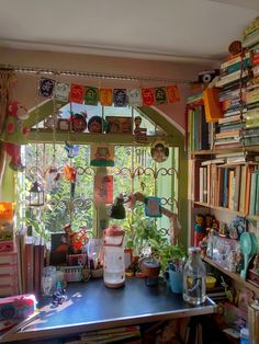 a room filled with lots of clutter and books on top of a blue table