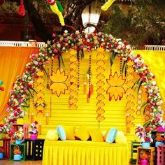 a stage decorated with flowers and decorations for a wedding or other special event in bright colors