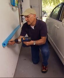 a man is painting the side of a car