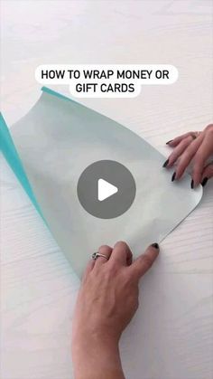 someone is wrapping money or gift cards on the table with text overlay that reads, how to wrap money or gift cards