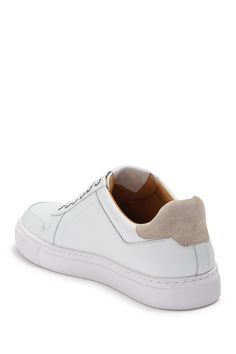 White shoes always add a fresh and clean look to an outfit. This leather sneaker is sporty yet classy with contrasting suede details and sleek silhouette.Sizing: True to size. Modern Lace-up Sneakers With Stitched Sole, Sporty Low-top Slip-on Sneakers With Stitched Sole, White Suede High-top Platform Sneakers, White Low-top Suede Platform Sneakers, White High-top Suede Platform Sneakers, White Sports Sneakers With Stitched Sole, White Suede Platform Sneakers With Textured Sole, White Platform Sneakers With Contrast Sole For Light Sports, Modern Sneakers With Gum Sole For Light Sports