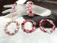 Heart Bracelets For Women, Valentine Mother's Day Bracelet Gift For Her, Handmade Hand Painted Glass Beaded Stretch Bracelet, Pack of 6  Material: glass beads, plastic spacer Size: 7.5 inch length x 2.25 inch circumference inner diameter will fit most woman small to medium wrist  Quantity: 6 pcs (1 pc each from the picture) Color: Pink, Red, Purple, White Design on the beads: Heart, Star, LOVE, Gift Box, butterfly  Beaded Bracelet - Bracelet For Women - Gift For Her - Heart Beaded Glass Beads St Heart-shaped Beaded Bracelet For Valentine's Day, Adjustable Heart-shaped Stretch Bracelet For Valentine's Day, Red Heart-shaped Bracelets For Valentine's Day, Valentine's Day Heart-shaped Stretch Bracelet With Colorful Beads, Valentine's Day Heart-shaped Colorful Bead Stretch Bracelet, Boho Bracelets Stack, Valentines Bracelets, Christmas Bracelet, Festival Jewelry