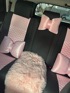 the interior of a car with pink and black bows