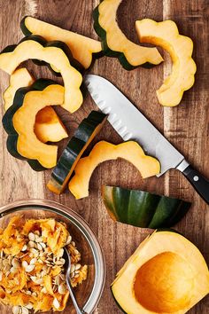 a cutting board with some cut up pumpkins on it and a knife next to them