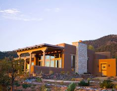 a house in the desert with mountains in the background