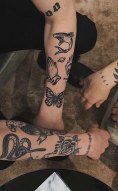 two people with tattoos on their arms and legs