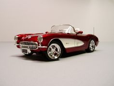 a red and white model car is shown