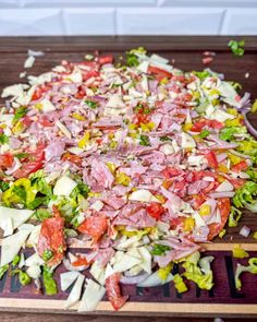 chopped up vegetables on a cutting board ready to be tossed into the oven for cooking