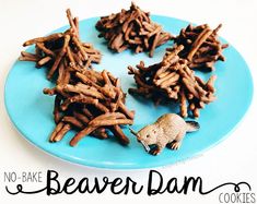 there are no bake beaver dan cookies on the blue plate, and one is made out of sticks