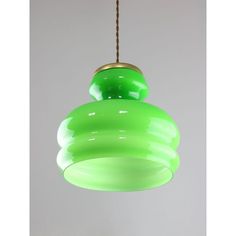 a green light fixture hanging from a ceiling