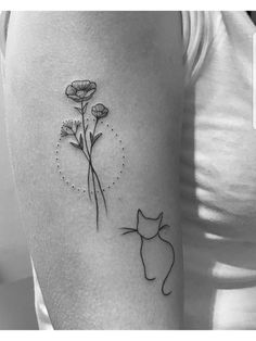 a woman's arm with a cat and flower tattoo on the left side of her body